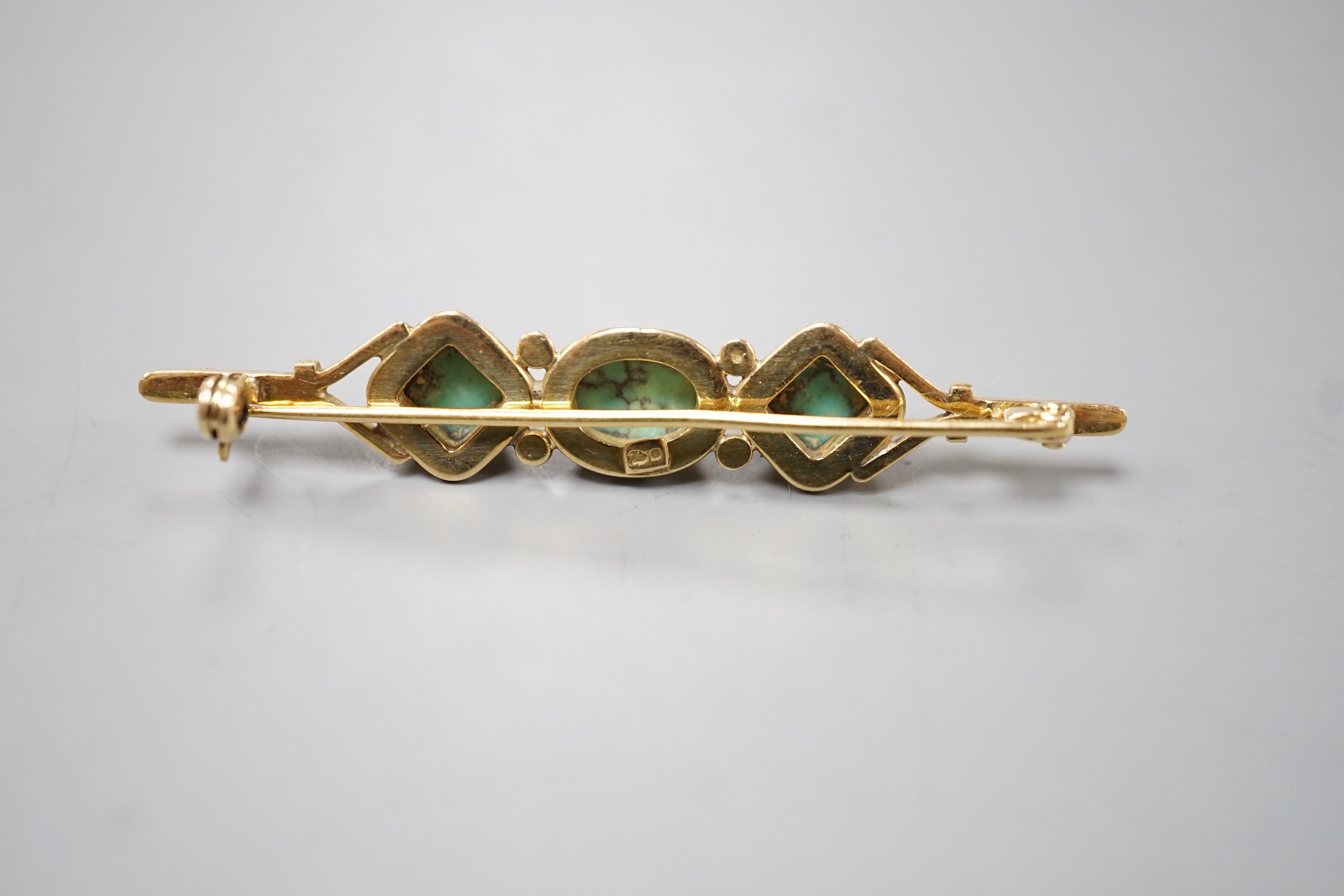 A 750 yellow metal and three stone shaped turquoise set bar brooch, 57mm, gross weight 6.6 grams.